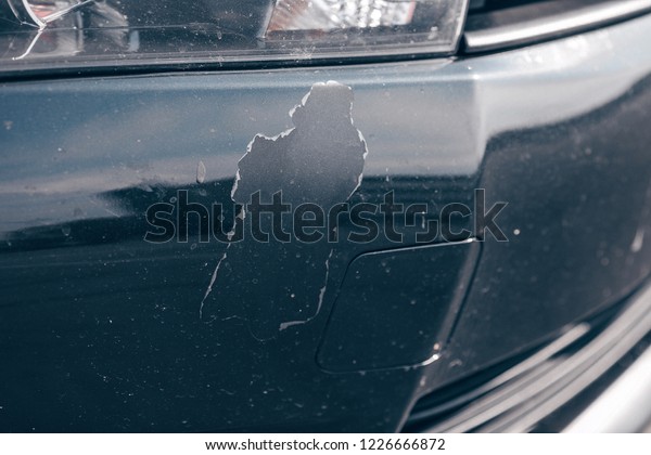 The black car paint cracked and peeled, the rusty\
old surface of car body\
