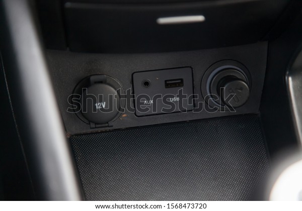 Black car panel with aux, usb connectors, 12V socket
and cork