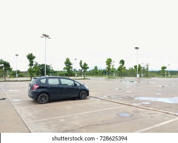 A Black Car Parked In A Single Car Park.