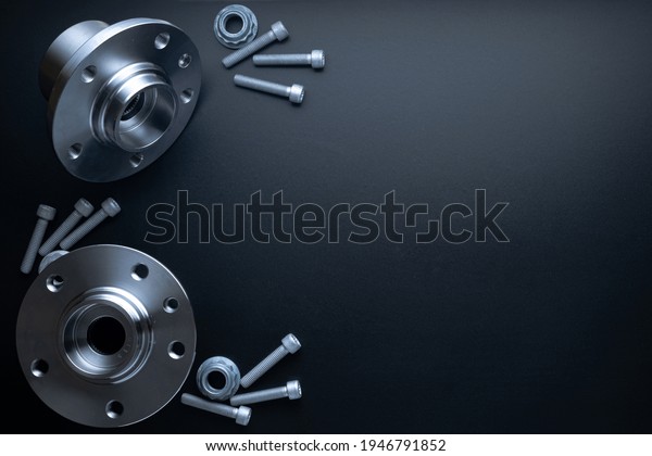 Black car part. Set\
of new metal car part. Auto motor mechanic spare or automotive\
piece isolated on dark background. Technology of mechanical gear\
with space for text