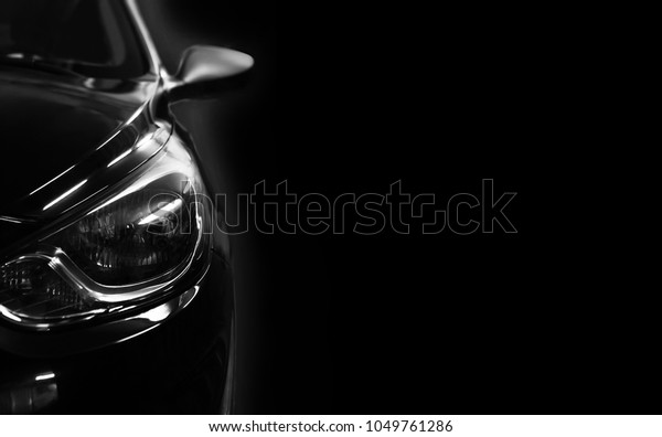 black car in
patches of light on black
background