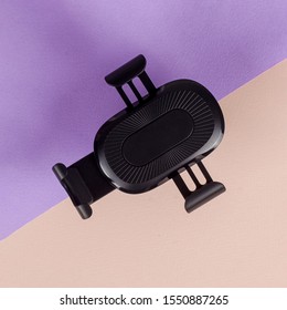 Black Car Phone Holder On Colorful Paper Background.