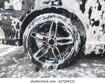 Black Car Rim In Car Wash 