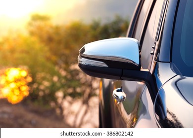 Black car side mirror with sun light effect. 