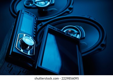 Black car sound speakers and radio tape recorder close-up on black background, audio system, hard bass subwoofer, control panel
