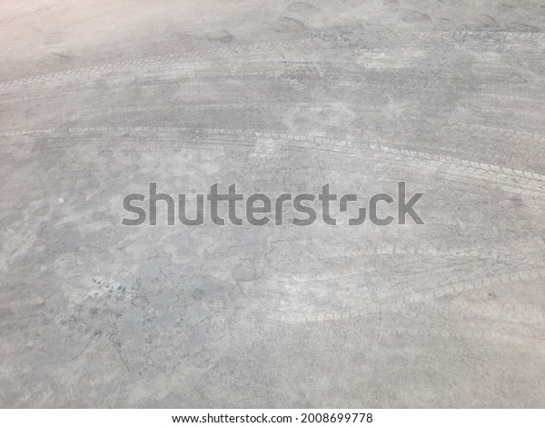 Black car tire floating on the road\
concrete., Cement floor For the background.\
