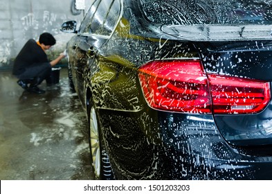 Black car wash with bubble soap. - Shutterstock ID 1501203203