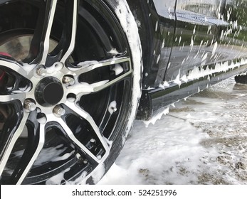 Black Car In Car Wash With Bubble Soap.