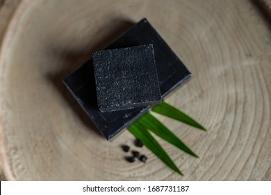 Black Carbon Charcoal Coal Soap In A Raw Wood Background 