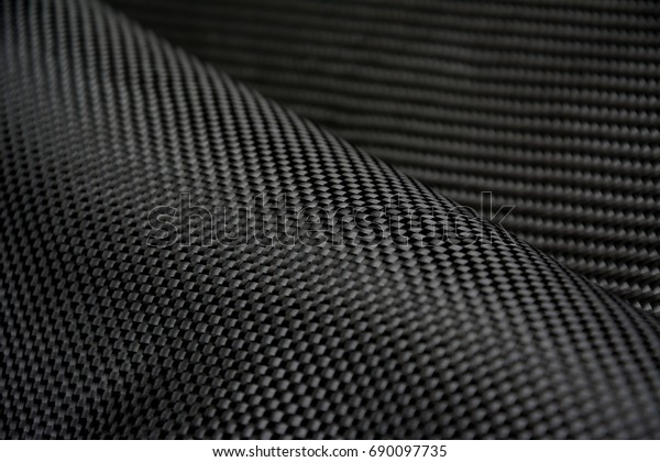 Black carbon fiber composite raw material\
close up background
