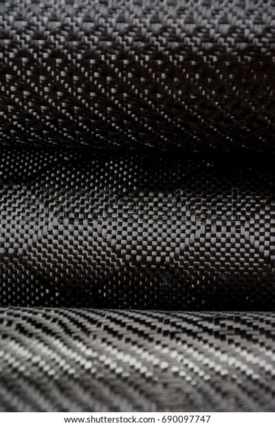 Black carbon fiber composite raw material\
close up background