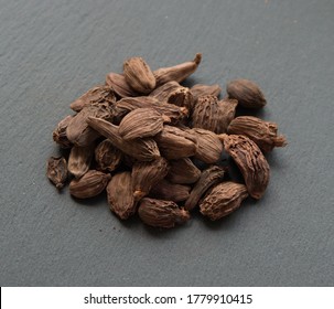 Black Cardamon (brown Cardamom, Amomum Subulatum) On Grey Background