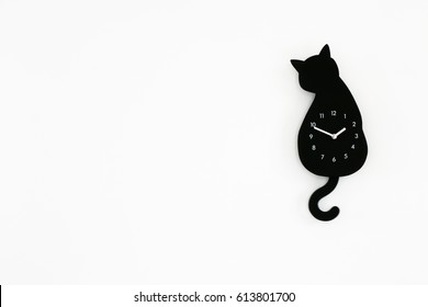 Black Cat Clock On White Wall Background 