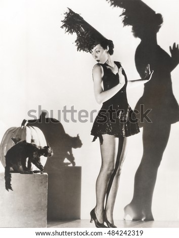 Black cat giving woman in costume the heebie-jeebies