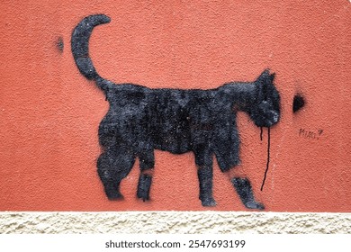 Black cat painted on the wall of a house in Liguria; art; murals; sweet black cat; I love animals - Powered by Shutterstock