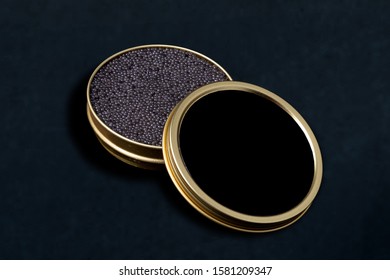 Black caviar in a jar on a black background