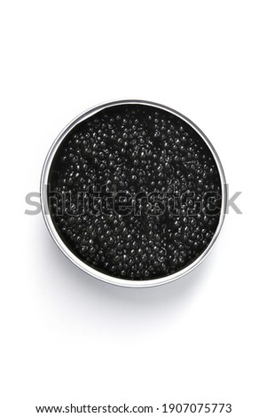 Black caviar in metal container isolated on white background. top view