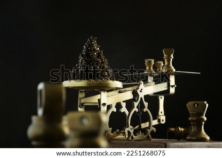 Black caviar on the scales. A delicacy of sturgeon fish. Brass antique scales. A symbol of wealth and luxurious life. A useful omega. An appetizer for exquisite parties.