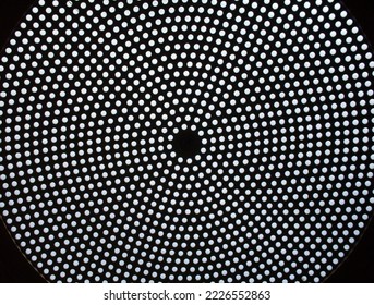 A black ceiling with a circular pattern of white dots - Shutterstock ID 2226552863