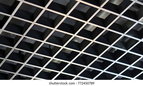A black ceiling made of grid.