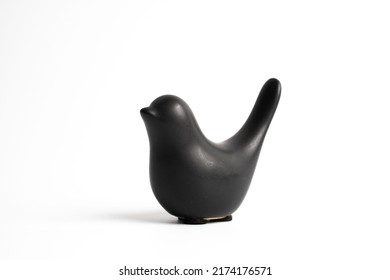 Black ceramic bird on white background