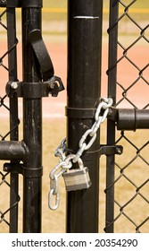 A Black Chain Link Fence And An Unlocked Gate