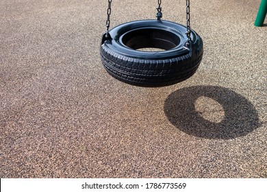 Black Chain Tire Swing At A Children's  Play Ground No People