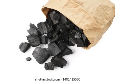 Black charcoal in a paper bag. Charcoal for igniting fire in a grill.
