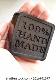 Black Charcoal Soap Bar, On Woman Hand, Skin Care Product, Using Hand Made Silicon Mold.
