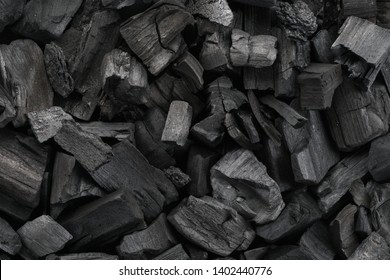 Black charcoal texture background. Close-up shot. Top view.