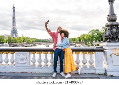 Black cheerful happy couple in love visiting Paris city centre and Eiffel Tower - African american tourists travelling in Europe and dating outdoors - Powered by Shutterstock