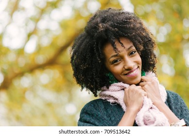 Black Cheerful Woman Portrait Wearing Warm Scarf In Autumn Season At The Park.