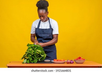 black chef sorting out cooking ingredients. female african chef, preparing ingredients for cooking