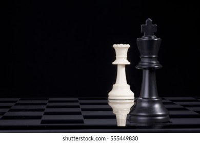 A Black Chess King In Checkmate By White Queen.