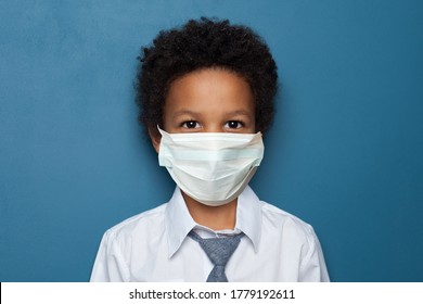 Black Child Boy Student In Medical Protective Face Mask On Blue Background