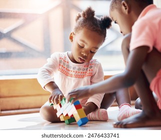 Black child, little girl and siblings playing with blocks or toys together on floor in living room at home. Young African, baby or toddler with playful sister for bonding, help or building at house - Powered by Shutterstock