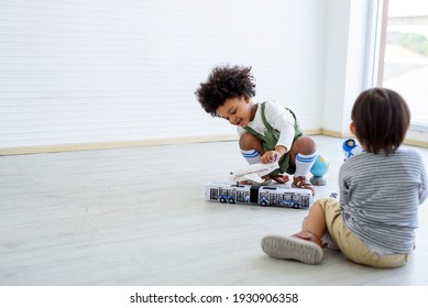 Black children and white children play with toys and have fun. Concept of apartheid And racism