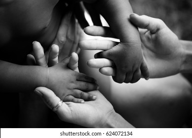 Black children's hands hold white hands of adult. Friendship, Adoption and care. Joy of parenting. Trust and family. Happy childhood. African child. Hope for future, father mother and son or daughter
