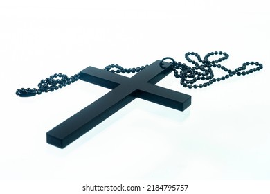 Black Christian Cross Necklace Isolated On White Background.