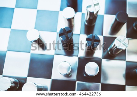 Black & chrome metallic chess on board. Business concept: Market competition and usurp business opportunities.