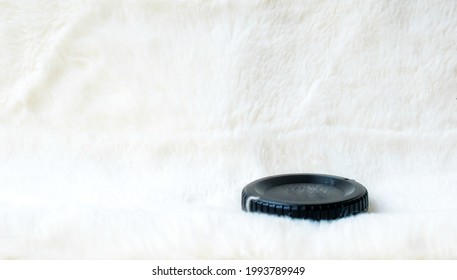 black circle stick base on white wool background