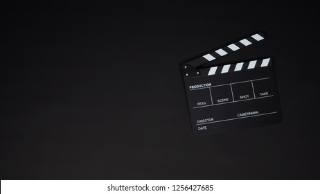 Black Clapper Board Or Movie Slate Use In Video Production ,film, Cinema Industry On Black Background.