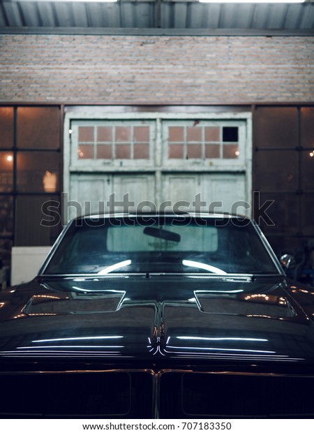 Black\
Classic American Muscle car in garage,Cars Auto Tuning Custom\
Muscle Retro Classic vintage,with copy\
space.