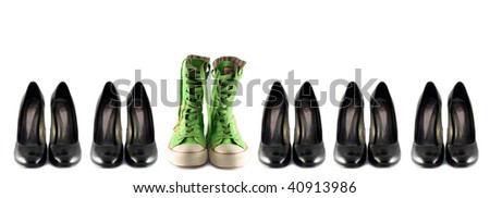 Black classic shoes and green boots  on the white background