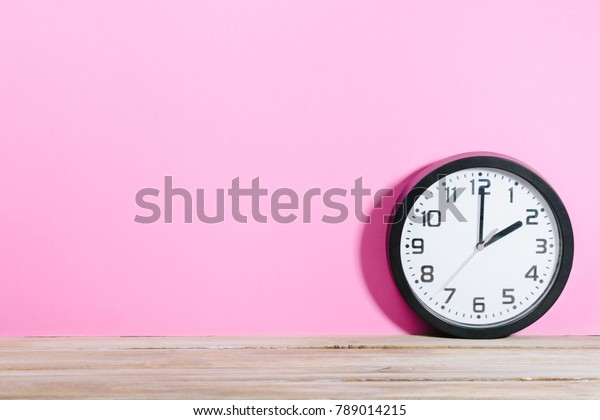 Black Clock Front Pink Colored Background Stock Photo Edit Now