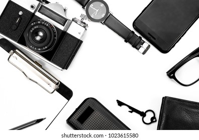 black clock,  black notepad, camera, black glasses, key, wallet on white background