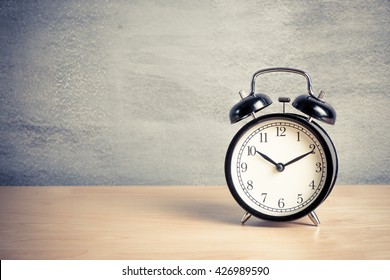 Black Clock On Wood Table