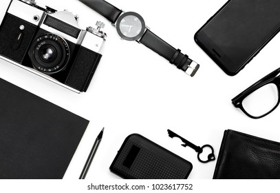 black clock, black pencil, black notepad, camera, black glasses, key, wallet on white background