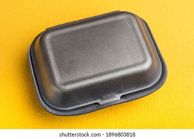 Black Closed Styrofoam Box On Yellow Background. Food Box For Food To Go, Delivery