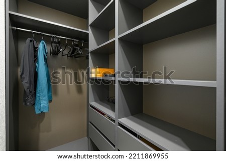 Black closet almost empty shelves closeup, wardrobe interior